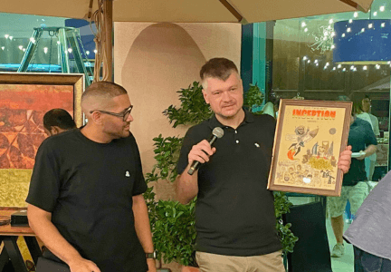 Ivan Grishkin presenting his artwork to Jamil Shinawi